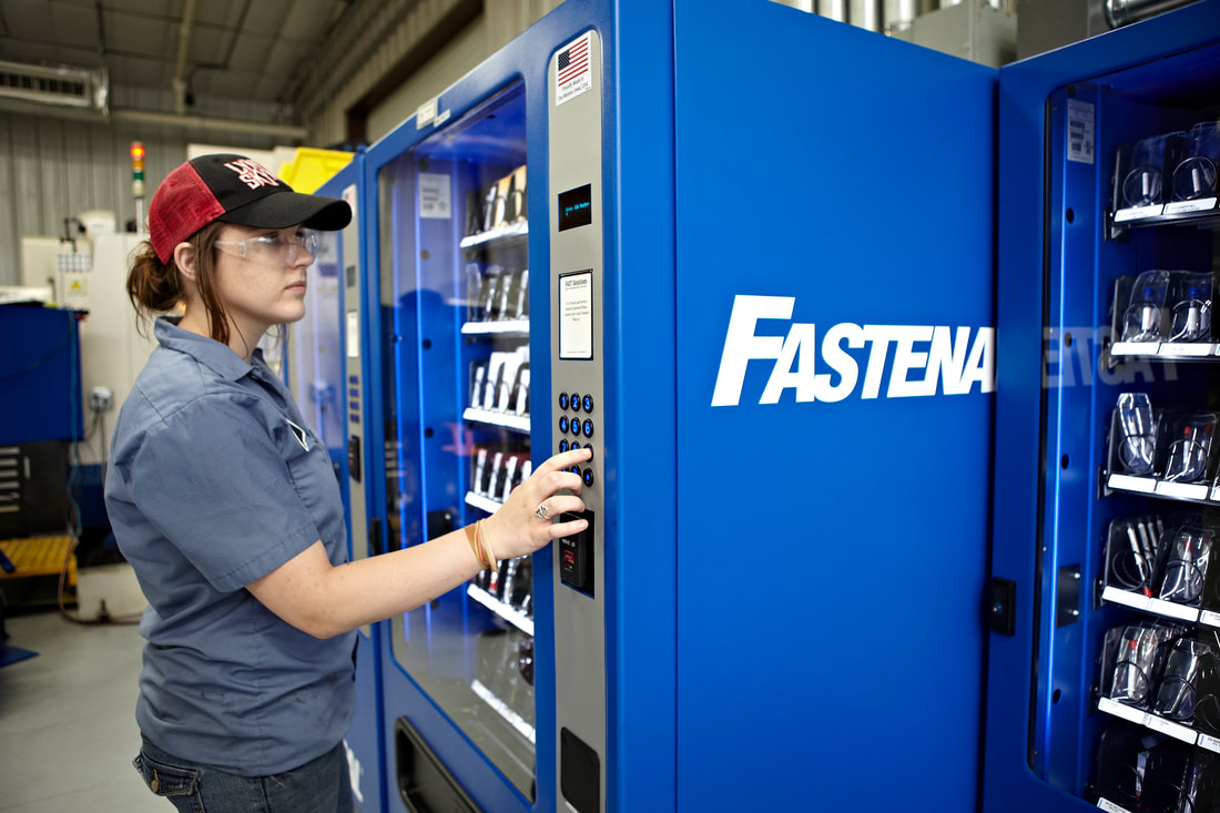 Woman receiving parts from vending machine