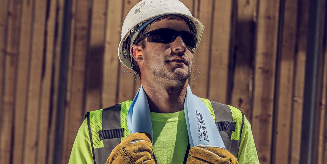 Construction worker with cooling towel