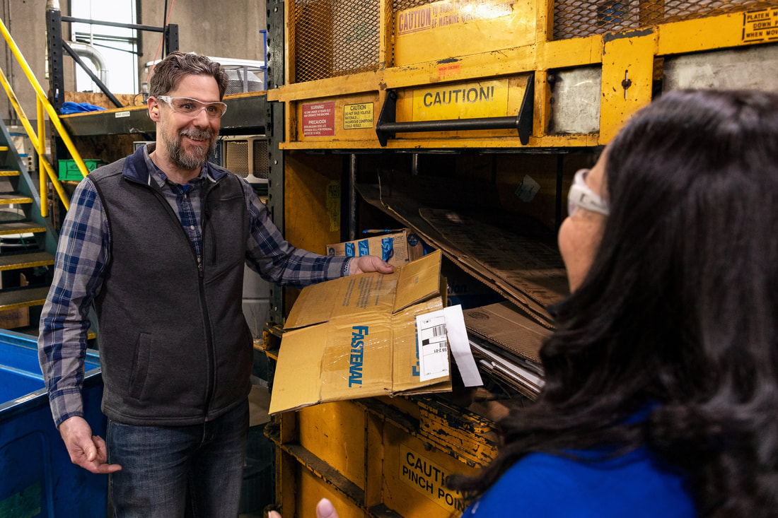 Fastenal employee showing worker recycling bin