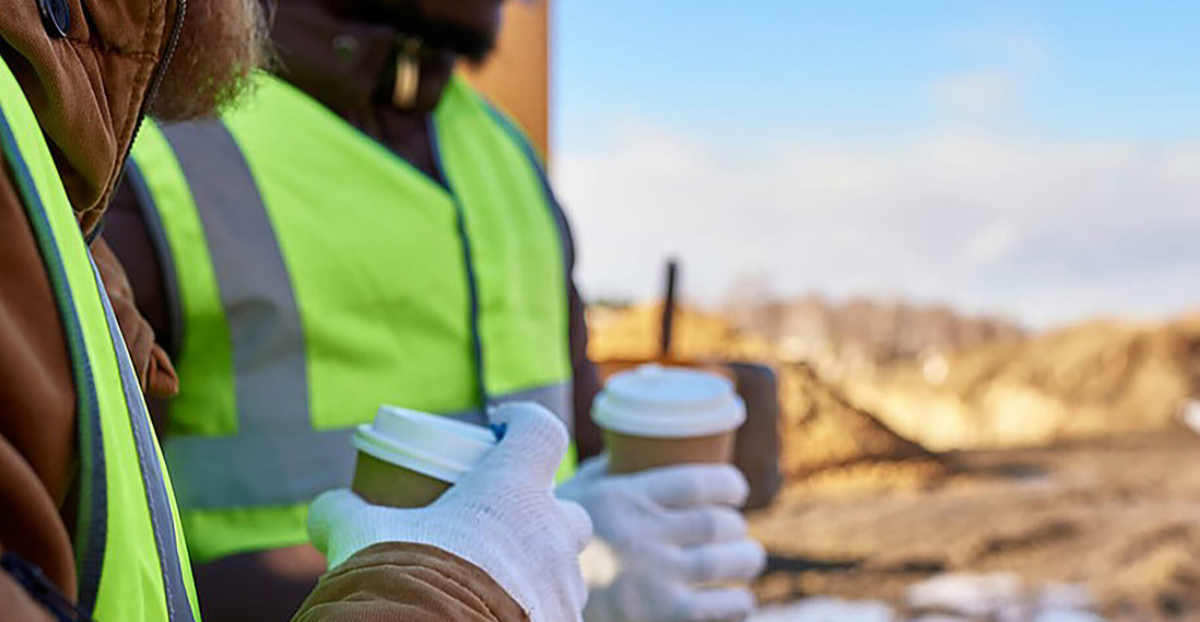 Employees holding coffee cups