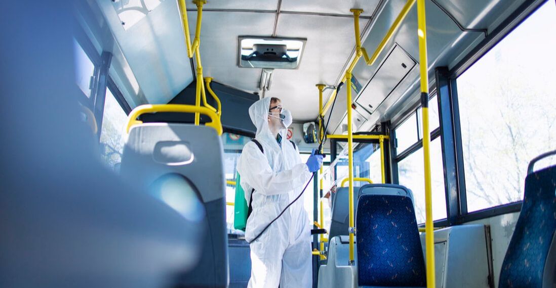 Employee cleaning bus