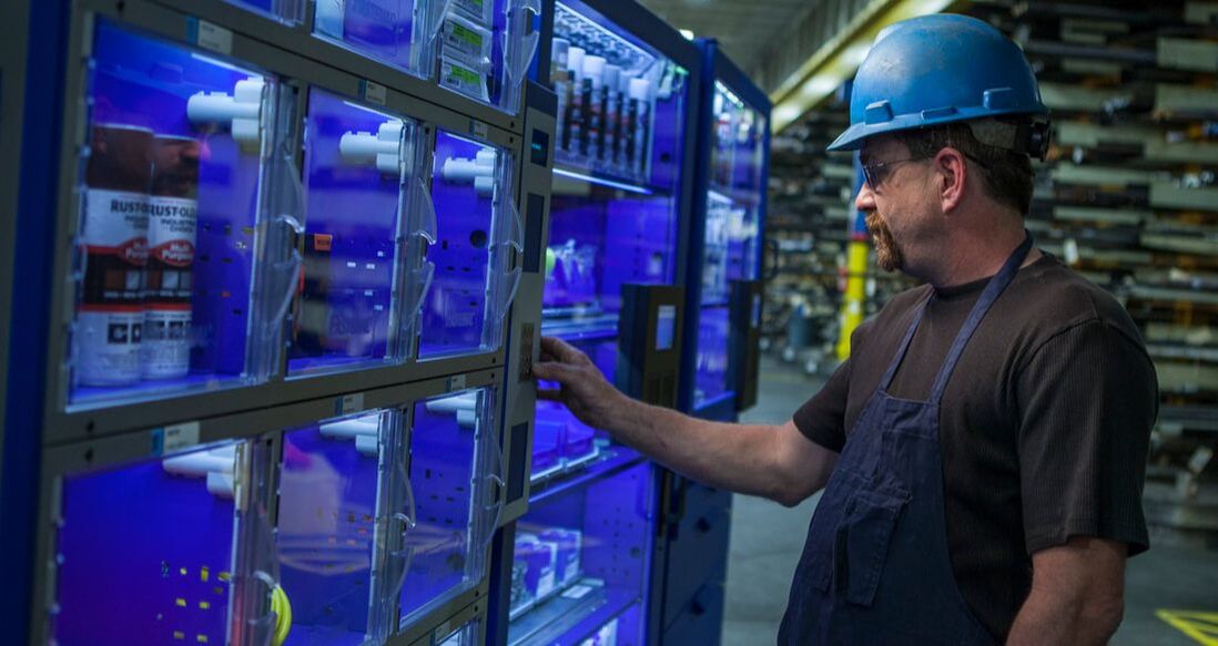 Employee in manufacturing facility using vending